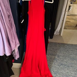 Size 2 red evening gown. Highneck low back  ruffle around bum and mermaid train